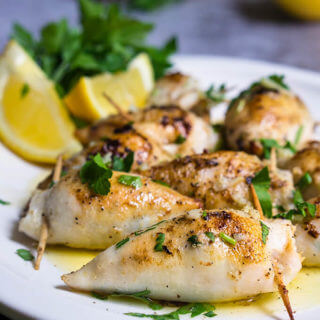 Stuffed calamari in lemon butter sauce - these delicious calamari bites are stuffed with creamy tuna filling, then cooked in a luscious tangy lemon butter sauce, with capers, garlic and lots of fresh parsley. | www.viktoriastable.com