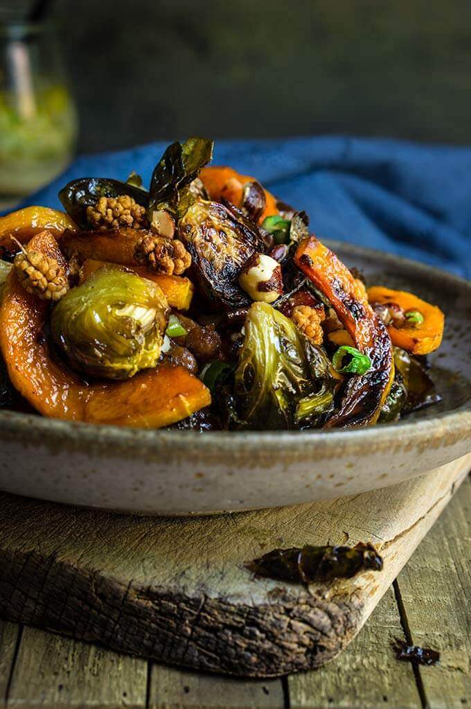 Roasted brussels sprouts and squash salad with horseradish dressing - this warm salad combines all the favorite flavors of fall - the sweetness of roasted veggies and dry fruit, with crunchy nuts, and a pungent horseradish dressing that ties them all in. | www.viktoriastable.com