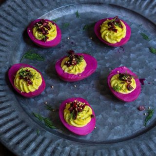 Beet-pickled curry deviled eggs - pickled in beet marinade for a gorgeous magenta color, then stuffed with a delicious curry filling, they make a spectacular appetizer, and a great way to utilize those leftover Easter eggs. | www.viktoriastable.com