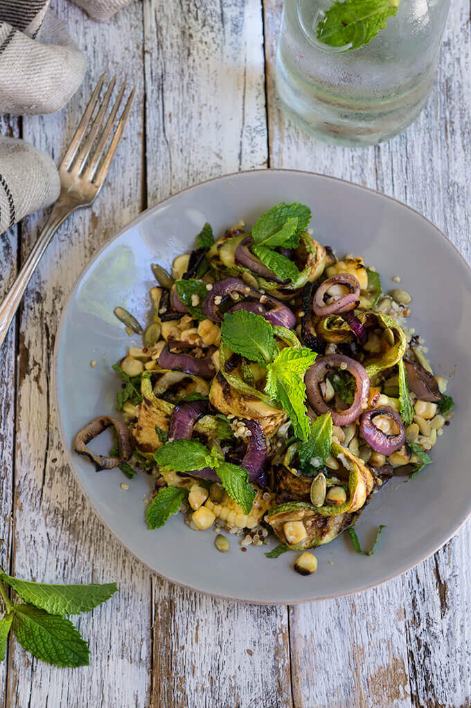 Grilled zucchini and corn quinoa salad - loaded with sweet, grilled summer veggies, healthy quinoa and crunchy toasted pepitas, and bursting with fresh, citrus and mint flavors - so bright, delicious and filling. | www.viktoriastable.com