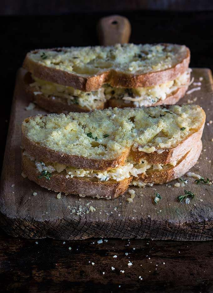 Garlic and herb loaded grilled cheese sandwich - four different cheeses, flavored with garlic and thyme, come into play, to create the ultimate, grilled cheese lover's dream sandwich. | www.viktoriastable.com