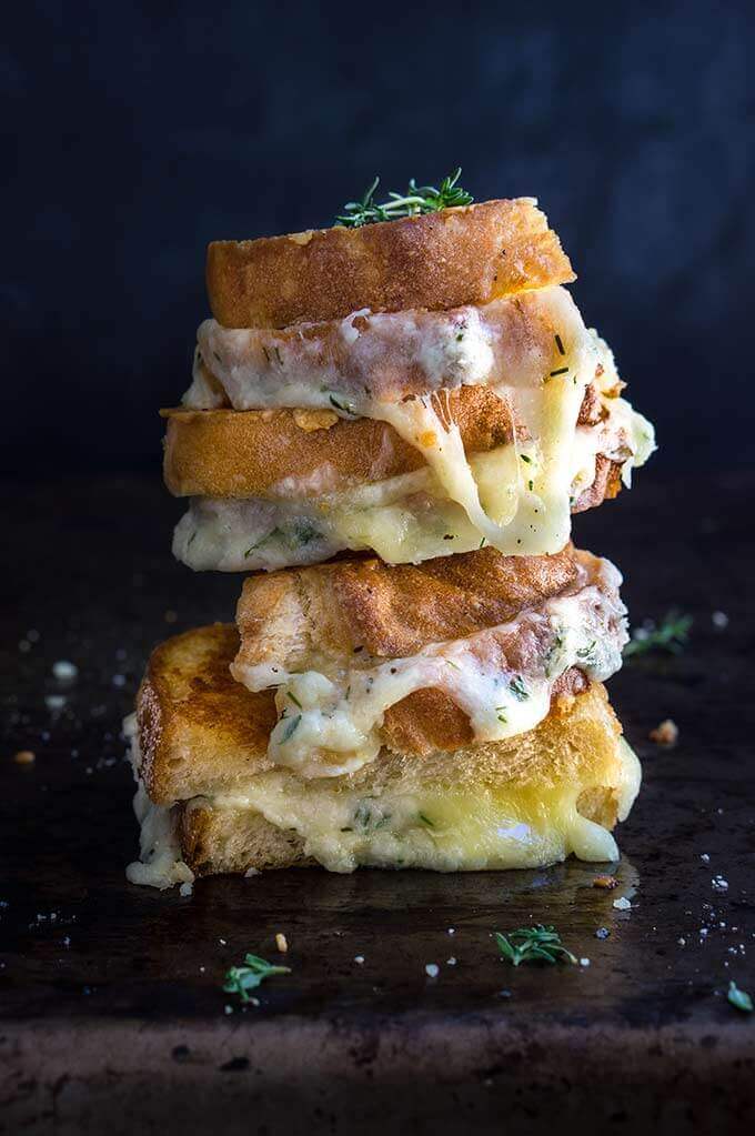 Garlic and herb loaded grilled cheese sandwich - four different cheeses, flavored with garlic and thyme, come into play, to create the ultimate, grilled cheese lover's dream sandwich. | www.viktoriastable.com