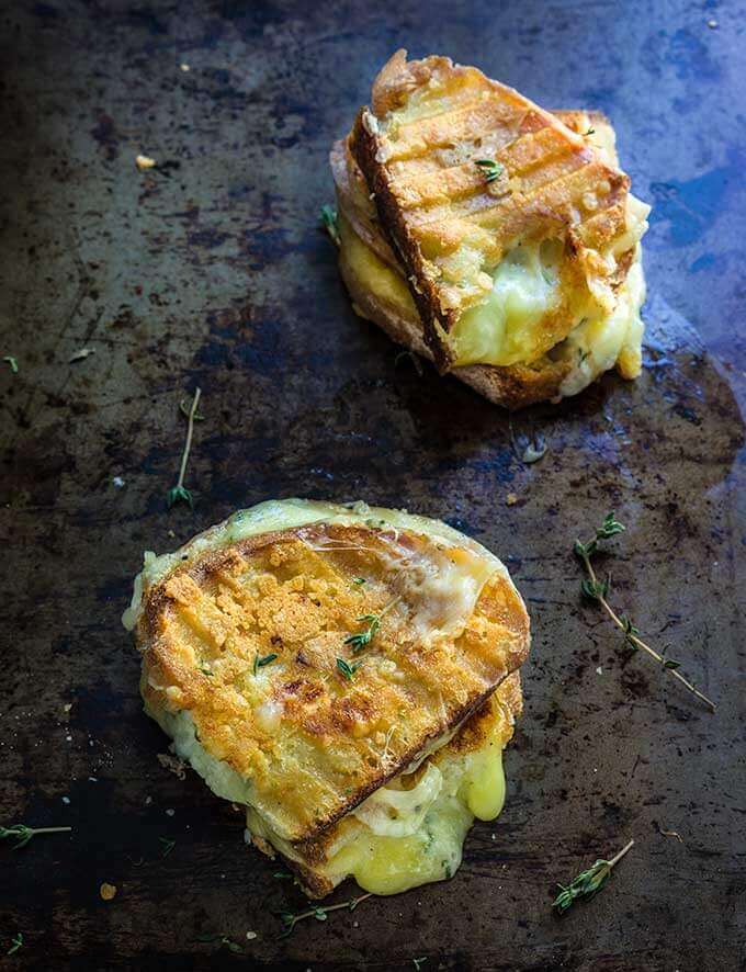 Garlic and herb loaded grilled cheese sandwich - four different cheeses, flavored with garlic and thyme, come into play, to create the ultimate, grilled cheese lover's dream sandwich. | www.viktoriastable.com