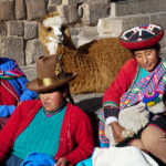 Quechua ladies posing with their llamas - San Blas, Cusco