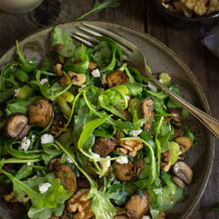 Mushroom and arugula salad with goat cheese, toasted walnuts, and celery - tossed in shallot mustard and truffle oil vinaigrette, this salad is bursting with earthy, fall flavors. | www.viktoriastable.com