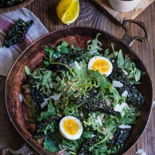 Kale salad with low fat Caesar dressing - baby kale and roasted kale chips, garlicky bread crumbs, and soft boiled eggs, drizzled with a healthy Caesar dressing which is packed with protein, low in fat, yet creamy and robust in flavor. | www.viktoriastable.com